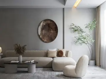 Nowoczesny salon w stylu minimalistycznym. Beżowa sofa, okrągły stolik kawowy, fotel i roślina w donicy tworzą przytulną przestrzeń.